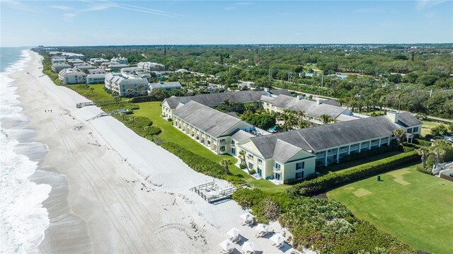 birds eye view of property with a beach view and a water view