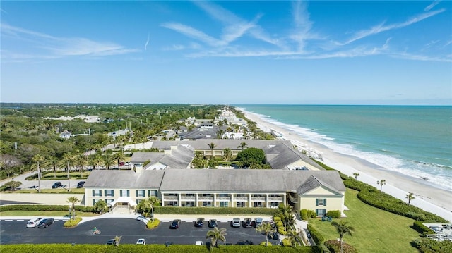 drone / aerial view featuring a view of the beach and a water view