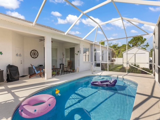 view of pool featuring ceiling fan, a patio, and a lanai