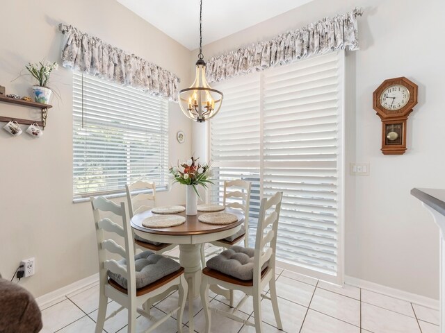 tiled dining room featuring a notable chandelier