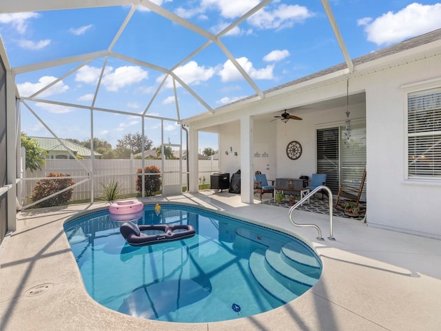 view of pool with a patio, ceiling fan, glass enclosure, and a jacuzzi