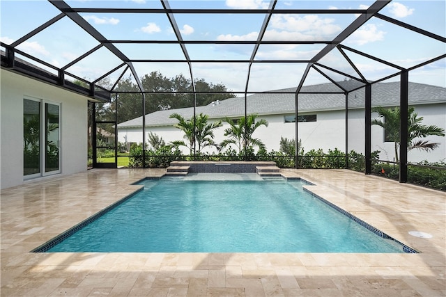 view of pool with pool water feature, a lanai, and a patio