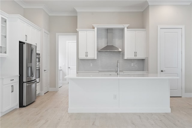 kitchen with white cabinets, wall chimney exhaust hood, and appliances with stainless steel finishes