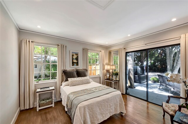 bedroom with access to outside, crown molding, and hardwood / wood-style floors