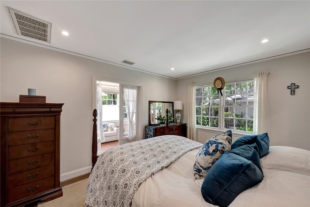 bedroom with crown molding and light hardwood / wood-style flooring