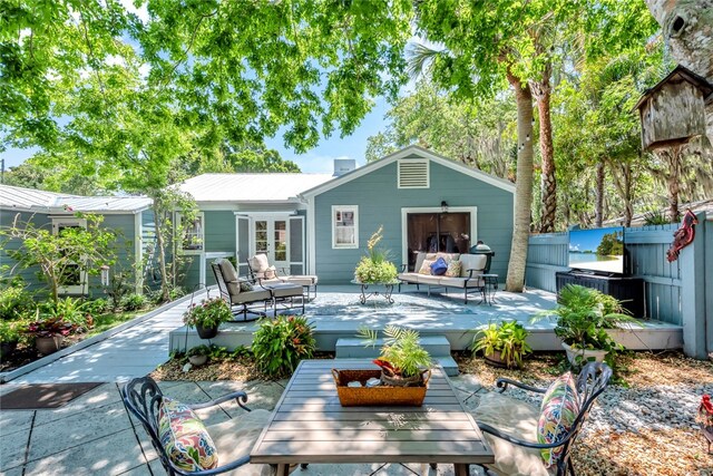 back of property with a patio and an outdoor hangout area