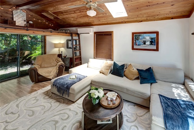 living room with wood ceiling, vaulted ceiling with skylight, a wall mounted AC, ceiling fan, and light hardwood / wood-style floors