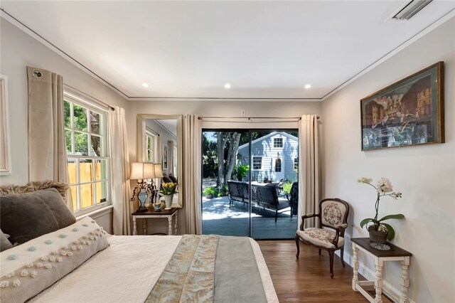 bedroom with access to outside, multiple windows, ornamental molding, and dark hardwood / wood-style floors