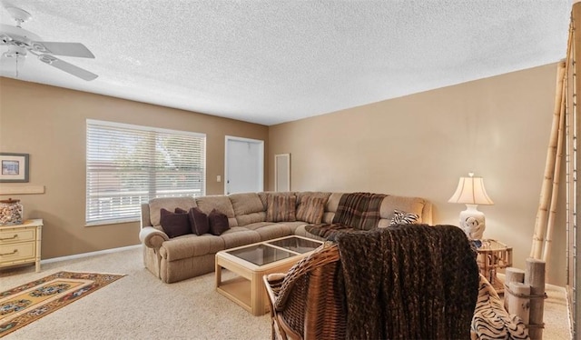 carpeted living room featuring a textured ceiling and ceiling fan