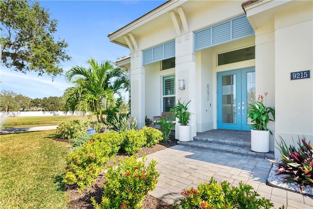 doorway to property with a yard and french doors