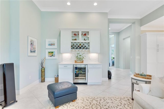9215 Orchid Cove Cir, Vero Beach, FL 32963 - indoor dry bar featuring beverage cooler, light tile patterned floors, ornamental molding, tasteful backsplash, and recessed lighting