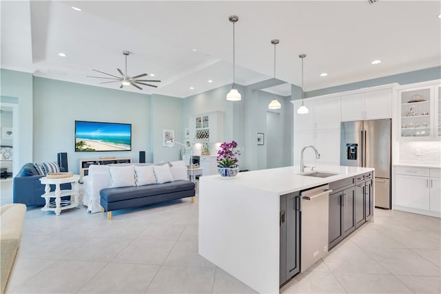 kitchen with appliances with stainless steel finishes, white cabinetry, pendant lighting, and sink