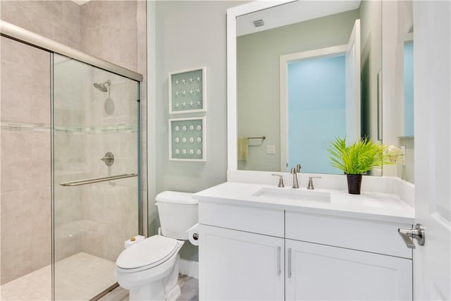 bathroom with vanity, toilet, and walk in shower