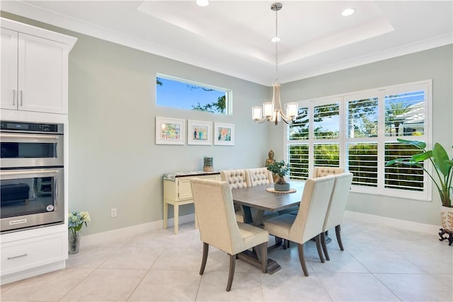 tiled dining area featuring a tray ceiling, an inviting chandelier, and crown molding