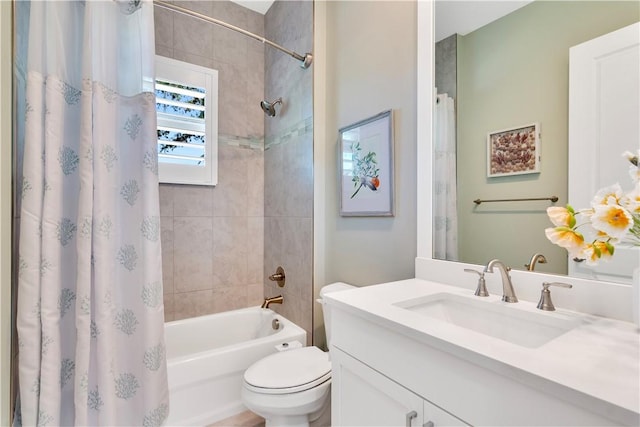 full bathroom featuring shower / bath combination with curtain, vanity, and toilet