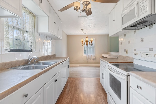 kitchen with white cabinetry, white appliances, and backsplash