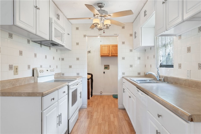 kitchen featuring white cabinets, light hardwood / wood-style floors, and white appliances