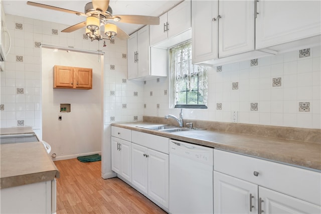 kitchen featuring white dishwasher, white cabinets, sink, ceiling fan, and light wood-type flooring