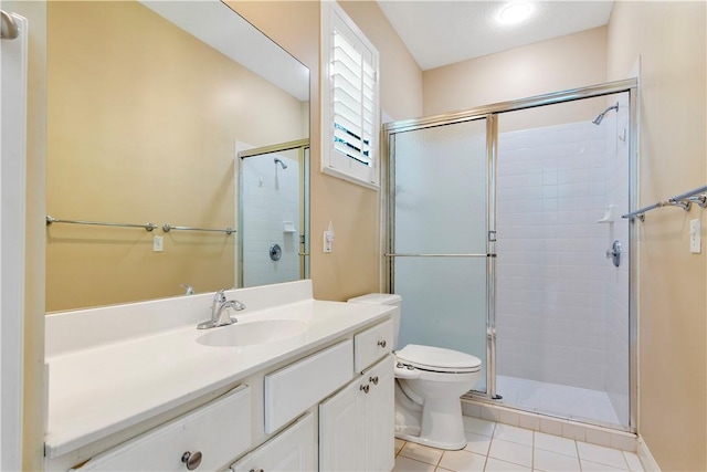 bathroom with vanity, toilet, an enclosed shower, and tile patterned flooring