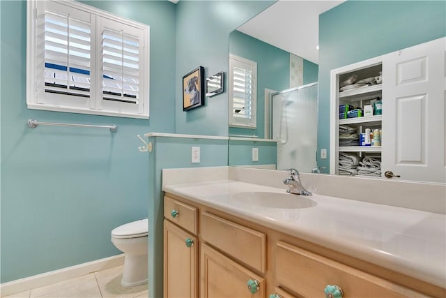 bathroom with a healthy amount of sunlight, a shower with door, tile patterned floors, and vanity