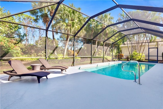 view of swimming pool with glass enclosure and a patio