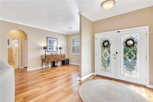 entryway featuring light hardwood / wood-style flooring and crown molding