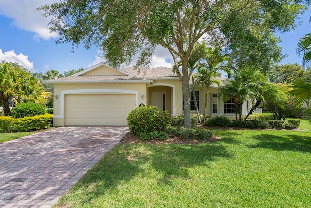 ranch-style house with a garage and a front lawn