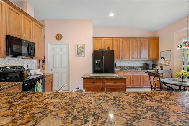 kitchen featuring black appliances, dark stone counters, backsplash, hanging light fixtures, and vaulted ceiling