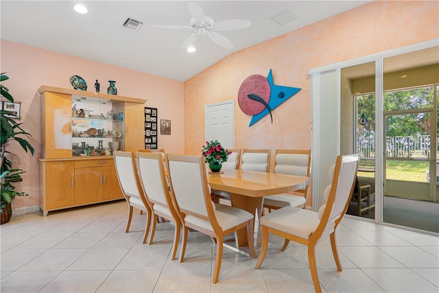 tiled dining area featuring ceiling fan and vaulted ceiling