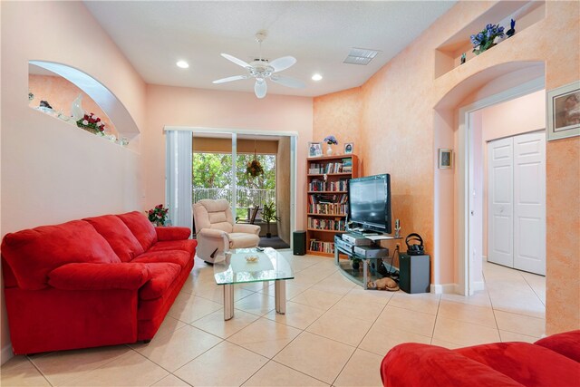 living room with ceiling fan and tile patterned floors