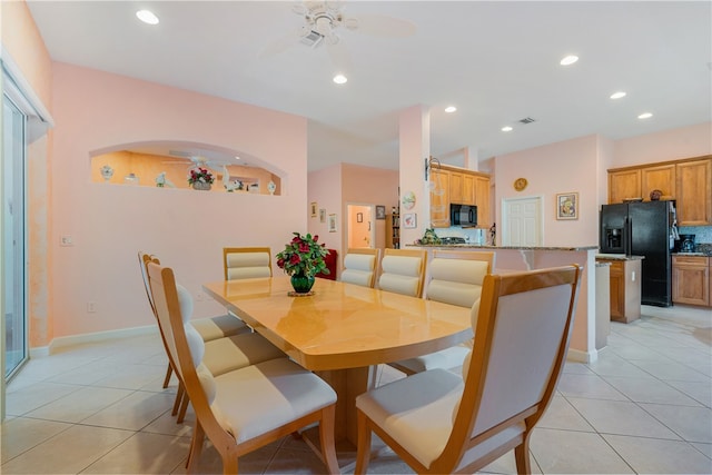 tiled dining space with ceiling fan