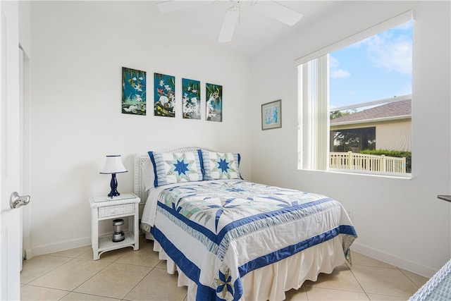 bedroom with ceiling fan and light tile patterned floors