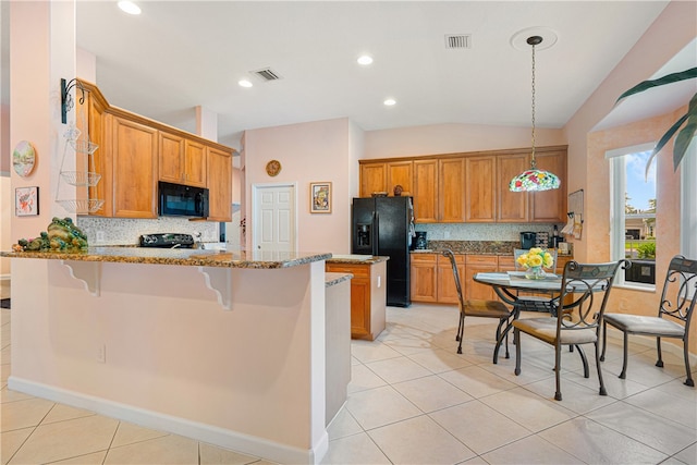 kitchen with lofted ceiling, kitchen peninsula, black appliances, light stone countertops, and pendant lighting