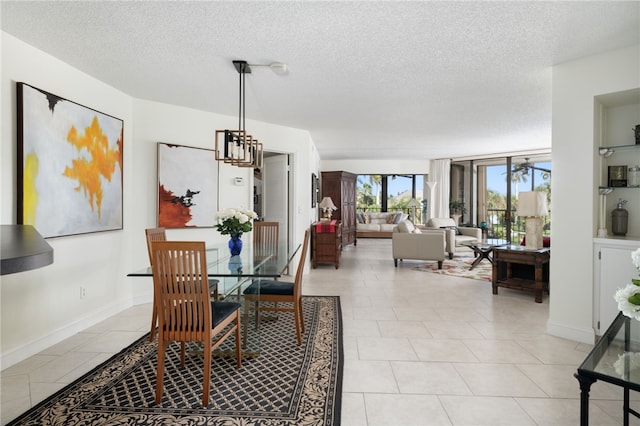 tiled dining area featuring a wall of windows, a textured ceiling, and a notable chandelier