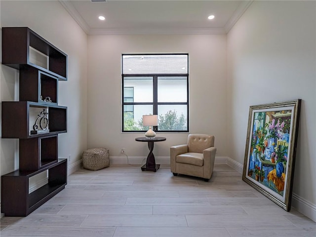 living area with ornamental molding and light wood-type flooring