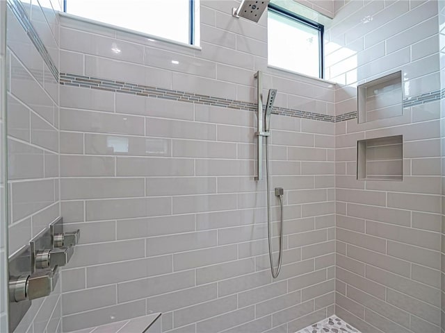 bathroom with a wealth of natural light and tiled shower