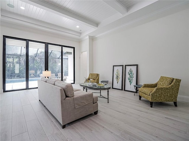 living room featuring beam ceiling and light hardwood / wood-style floors