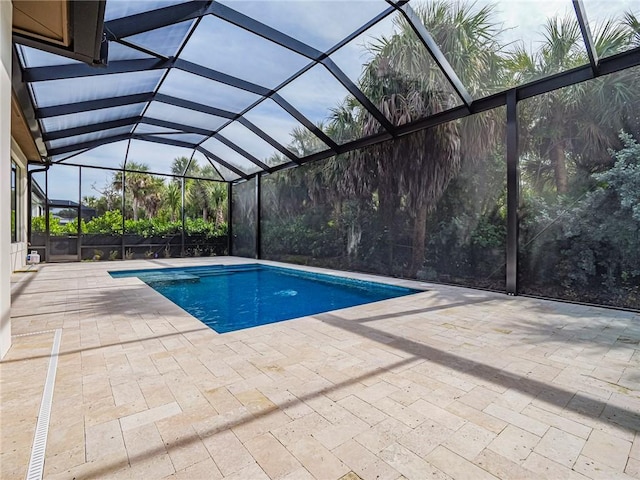 view of swimming pool with a patio and glass enclosure