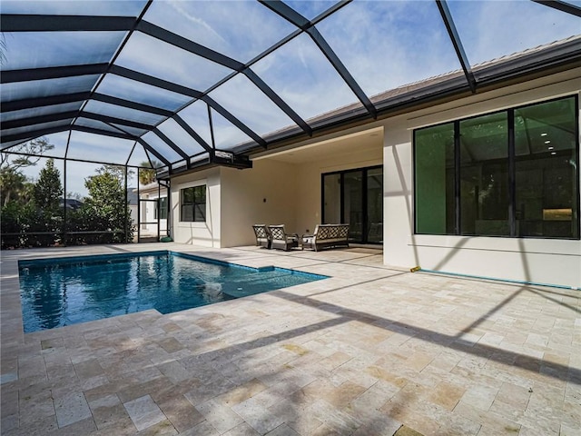 view of swimming pool featuring a lanai and a patio area