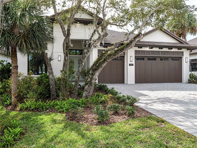 view of front of house with a garage and french doors