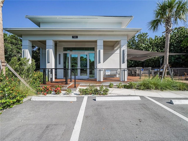 9139 Seaglass Ct, Vero Beach, FL 32963 - doorway to property with uncovered parking, covered porch, and stucco siding