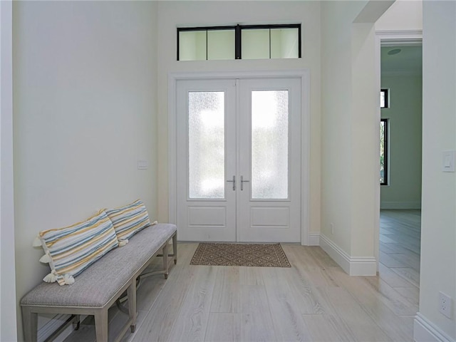 entrance foyer with light hardwood / wood-style flooring and french doors