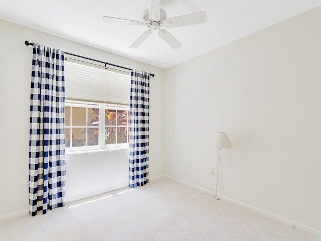 5540 N Harbor Village Dr Unit 103, Vero Beach, FL 32967 - carpeted spare room featuring baseboards and a ceiling fan