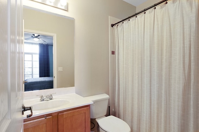 bathroom featuring vanity, ceiling fan, toilet, and a shower with curtain