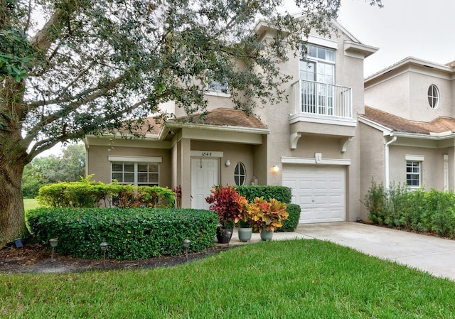 view of front of property featuring a garage, a front lawn, and a balcony