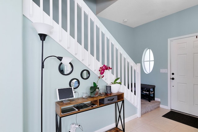 entrance foyer featuring a textured ceiling and light tile patterned floors