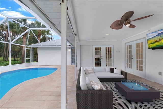 view of swimming pool featuring a lanai, an outdoor living space, french doors, and a patio