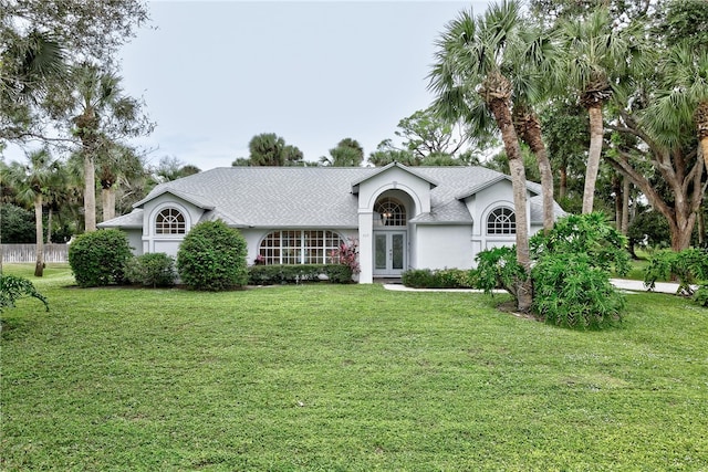 single story home featuring french doors and a front lawn