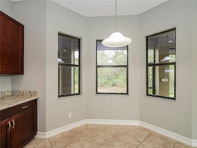 unfurnished dining area featuring light tile patterned flooring