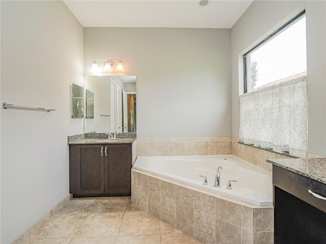 bathroom with tile patterned floors, a relaxing tiled tub, and vanity